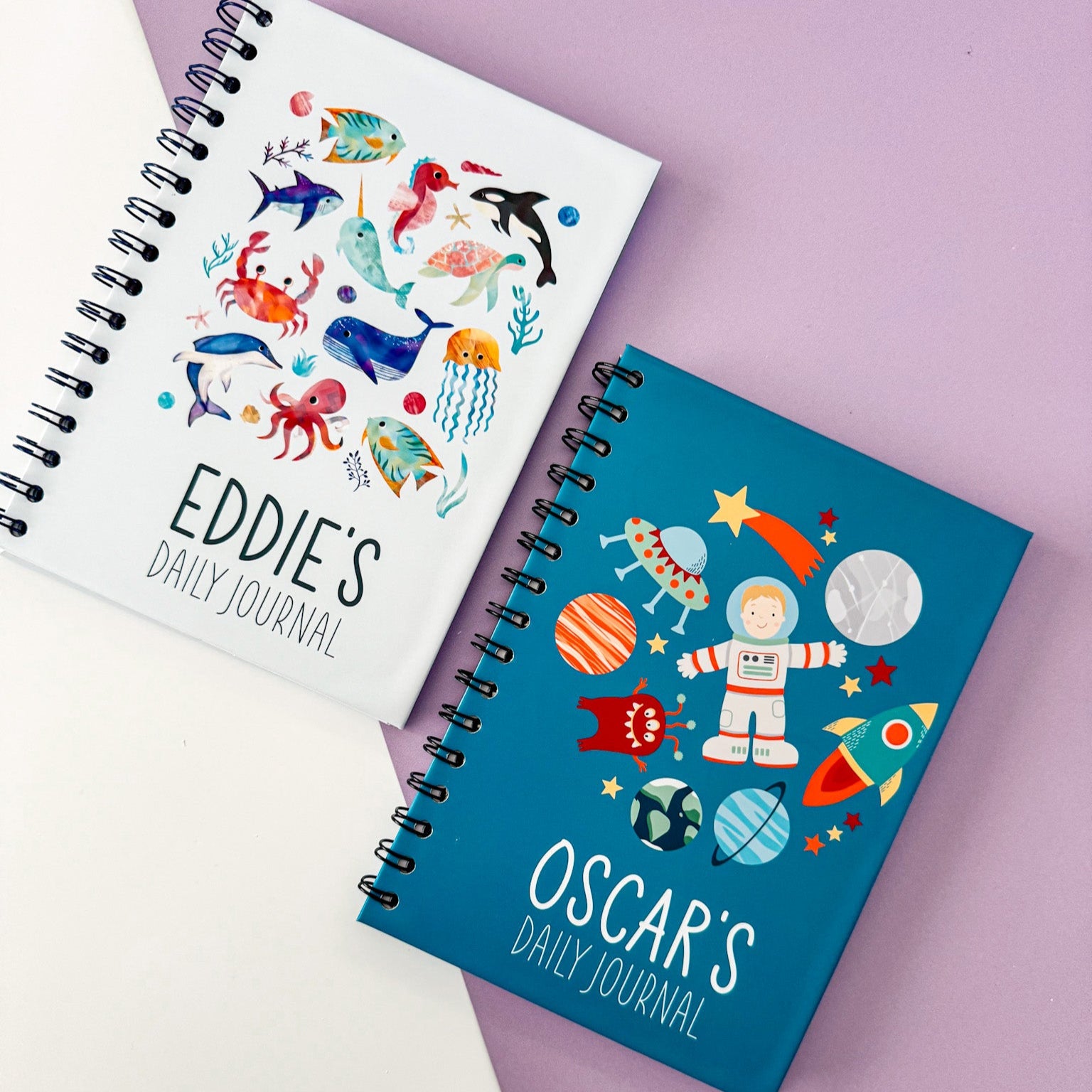 Side-by-side view of the personalised space and ocean-themed journals, showcasing their unique designs and adventure themes.