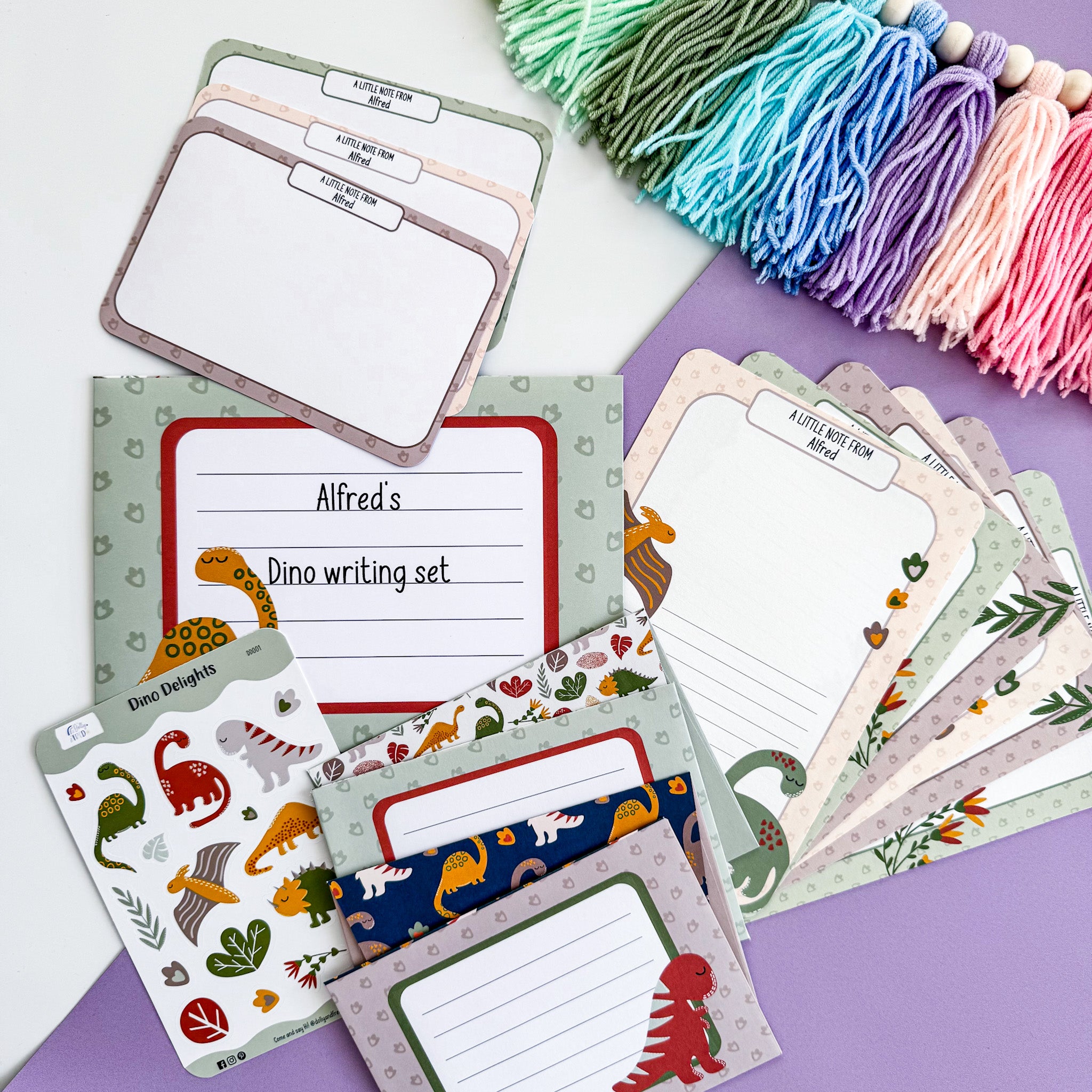 Fun and creative dinosaur-themed writing set for kids, including personalised stationery, postcards, envelopes, and stickers in a green dinosaur design.