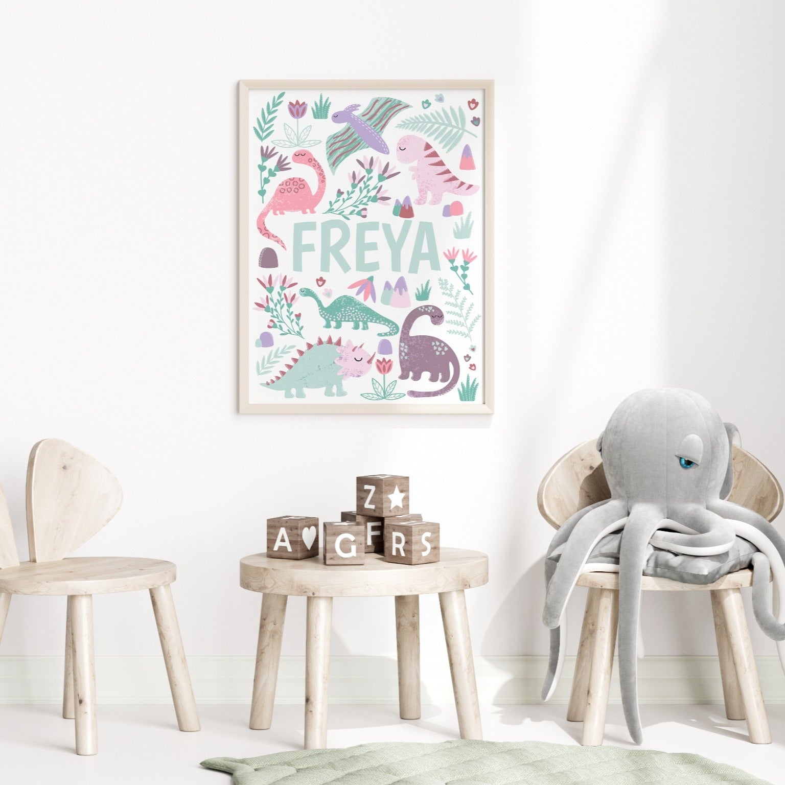 Detailed view of pink dinosaur wall art prints for nursery or kids' room decor.