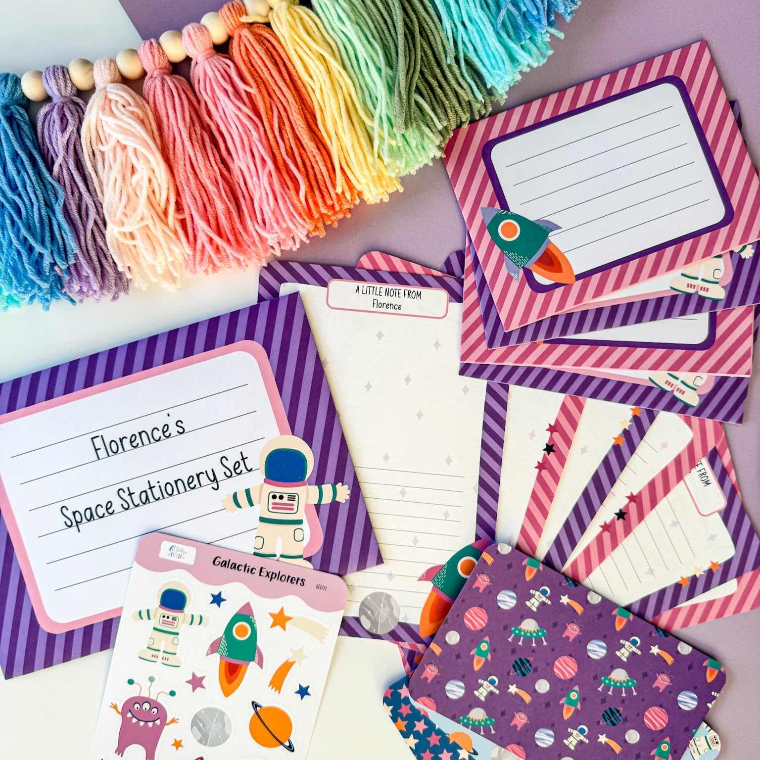 A full view of the girls' space writing set, showing letter paper, envelopes, stickers, and postcards.