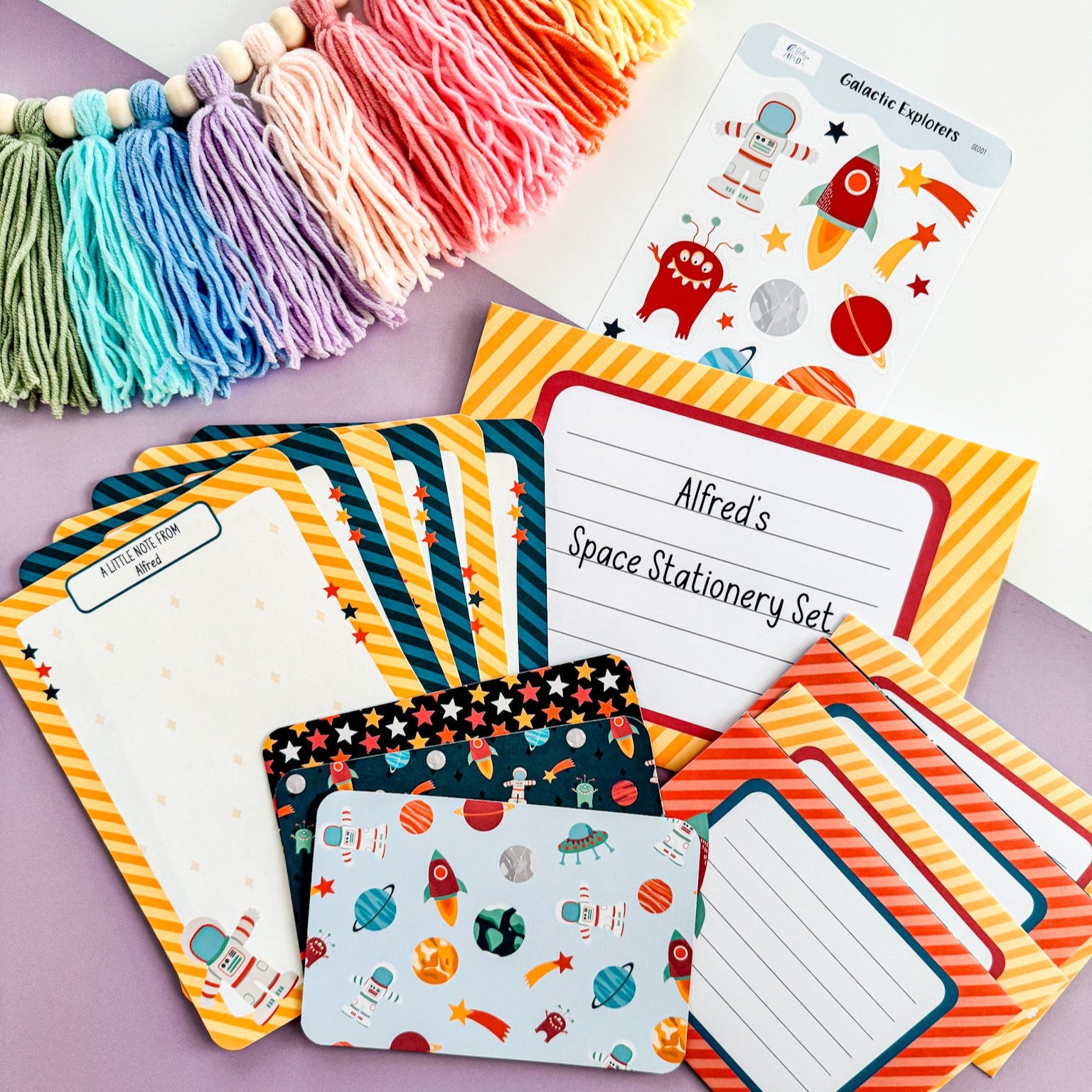 A full view of the boys' space writing set, showing letter paper, envelopes, stickers, and postcards.