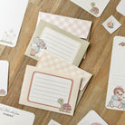 A stack of beautifully designed animal-themed writing paper and envelopes, perfect for kids to write letters to friends and family.