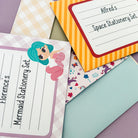 A collection of packaged children's writing sets in different designs, including a space-themed option.