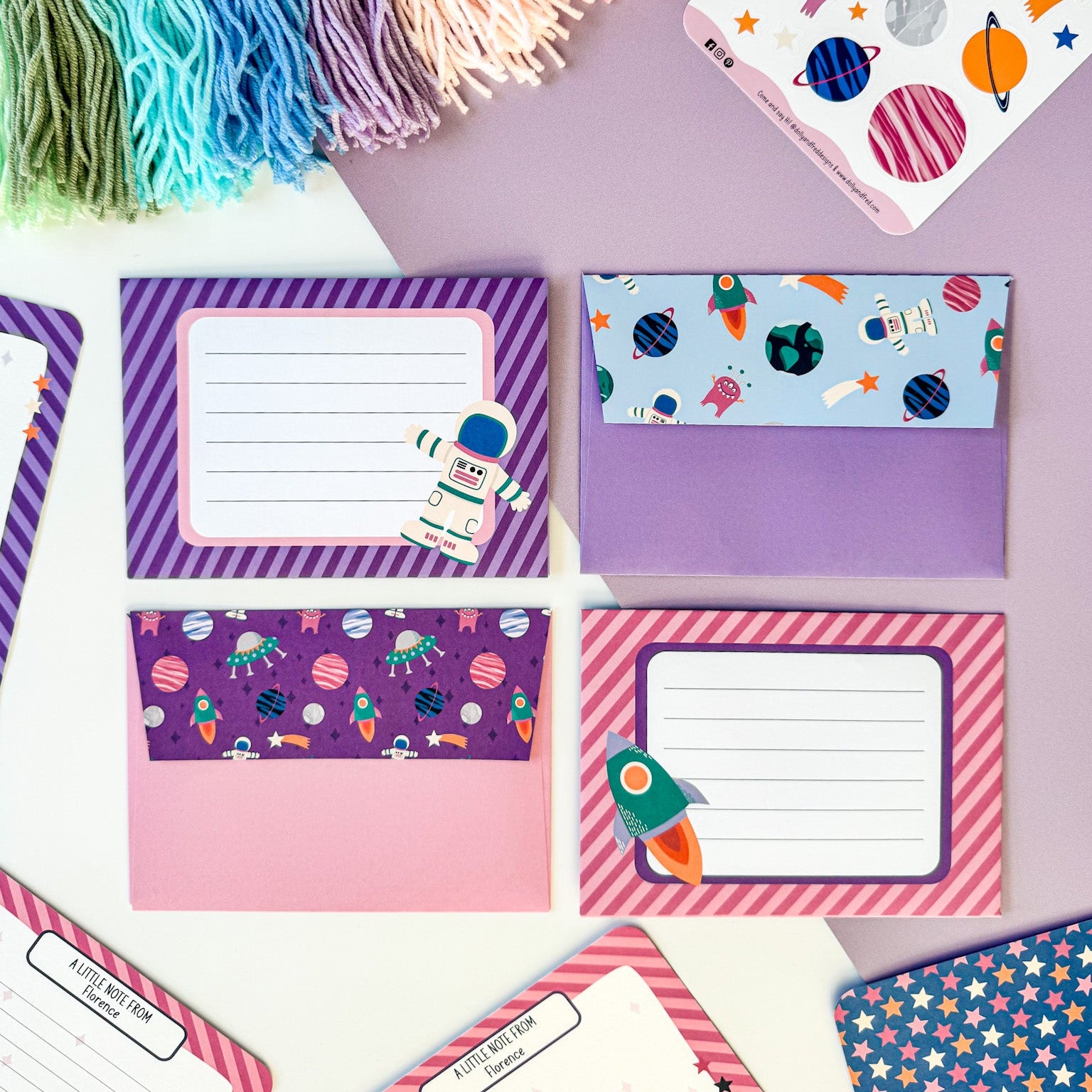 A set of space-themed envelopes decorated with stars and planets, included in a kids' stationery set.