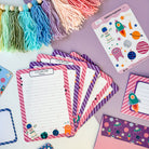 A set of six space-themed letter writing sheets for girls, decorated with planets and stars.